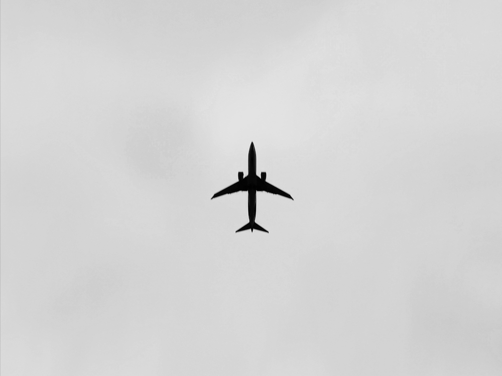 Photograph of an aeroplane flying to Heathrow Airport captured in Windsor, United Kingdom.